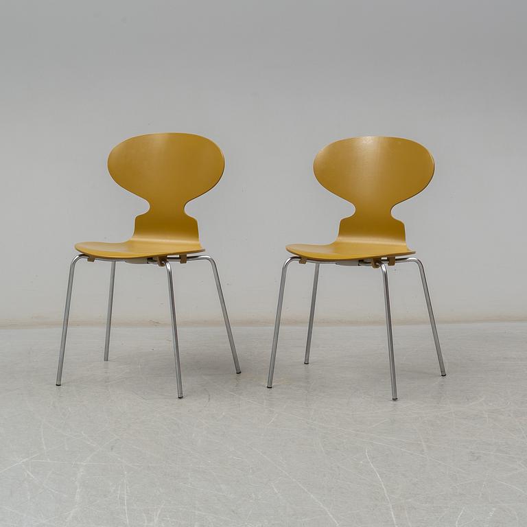 BRUNO MATHSSON & PIET HEIN, and ARNE JACOBSEN, a 'Supercirkel' table and two 'Myran' chairs, from Fritz Hansen.