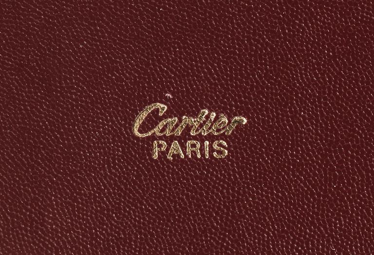 A bordeaux leather brief-case by Cartier.