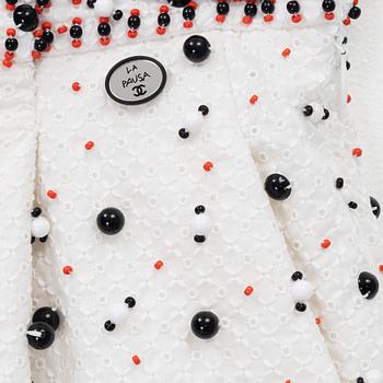 Chanel, a pair of broderie anglais trousers with pearls, size 34.