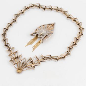 An ERTE necklace with a detachable pendant wearble as a brooch.