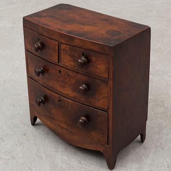 An early 19th Century Regency miniature chest of drawers.