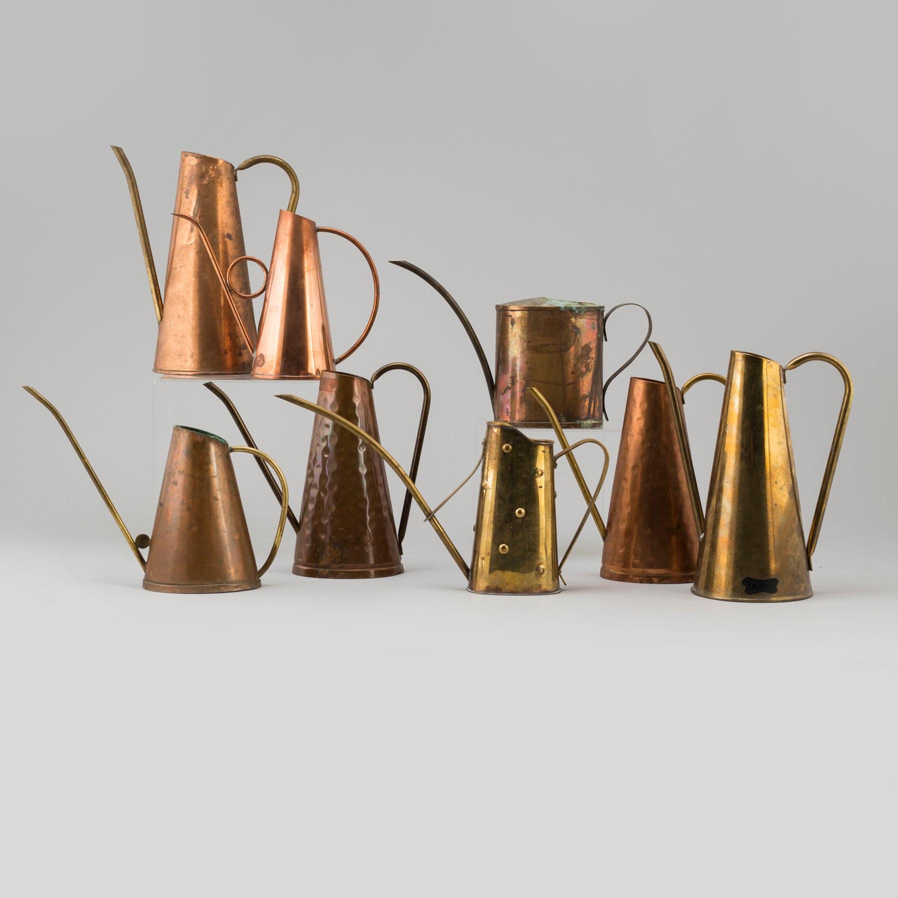 Eight 19th and 20th century copper and brass watering cans.