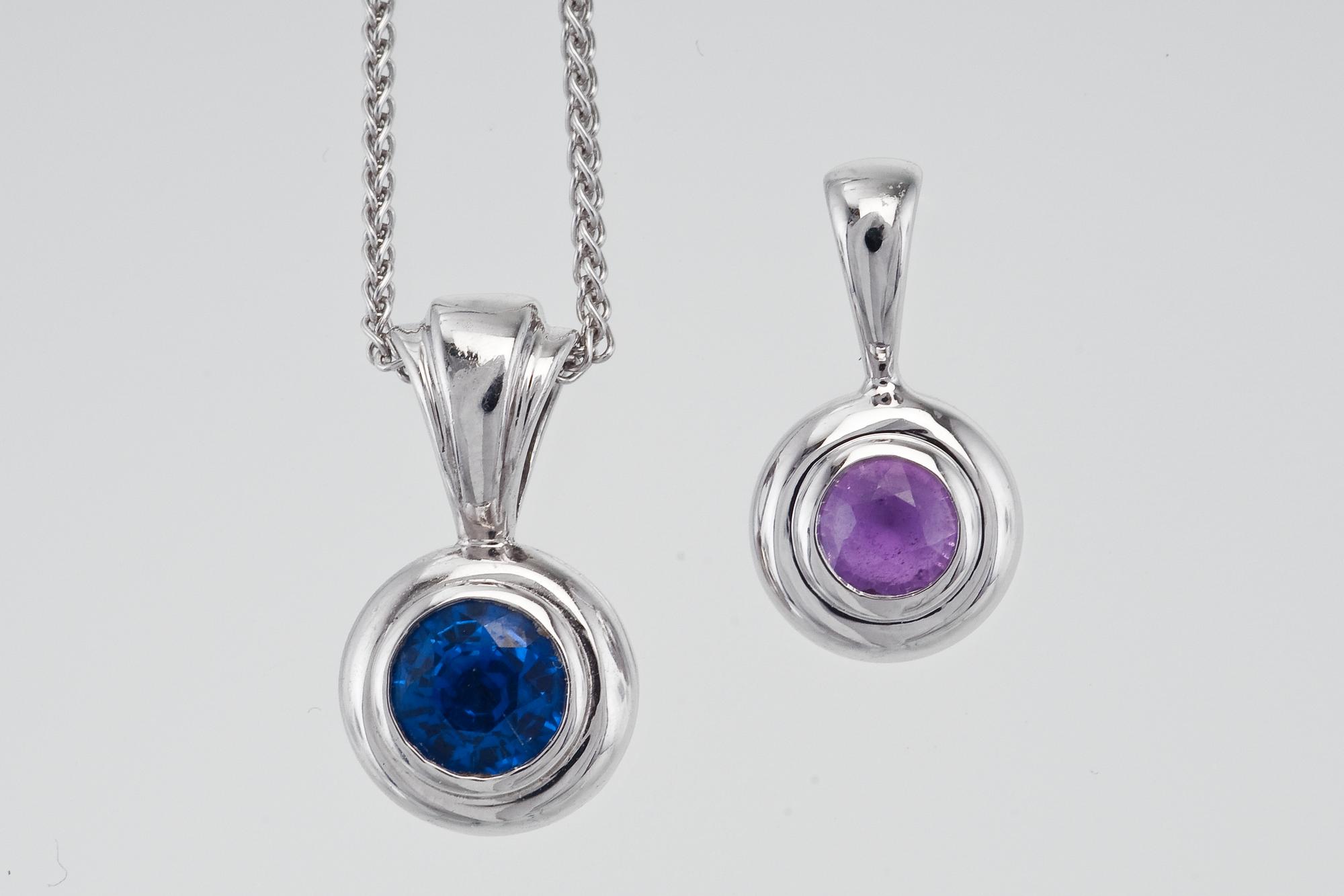 A CHAIN WITH TWO SAPPHIRE PENDANTS.