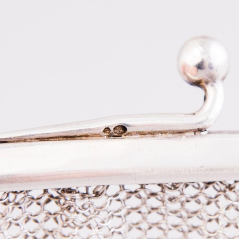 Two silver evening bags and a silver mirror, 1920s-1940s.