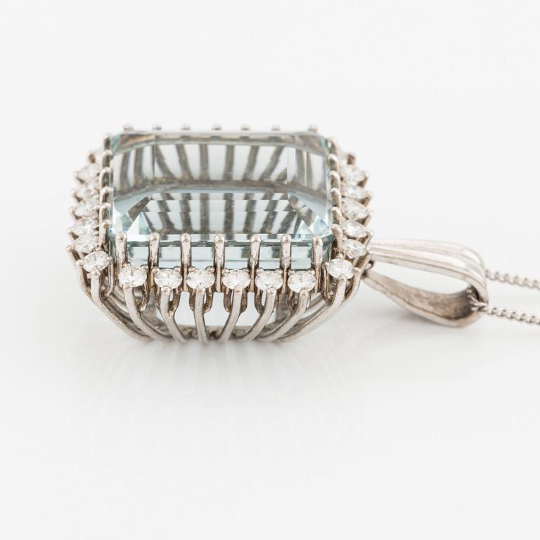 An 18K white gold Engelbert pendant set with a aquamarine and round brilliant-cut diamonds.