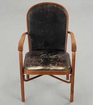 Sigurd Lewerentz, a stained beech and black leather armchair, Gemla, Sweden circa 1932.