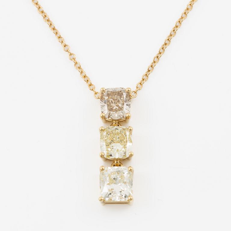 Pendant with chain in 18K gold set with a radiant-cut diamond and two cushion-cut diamonds.