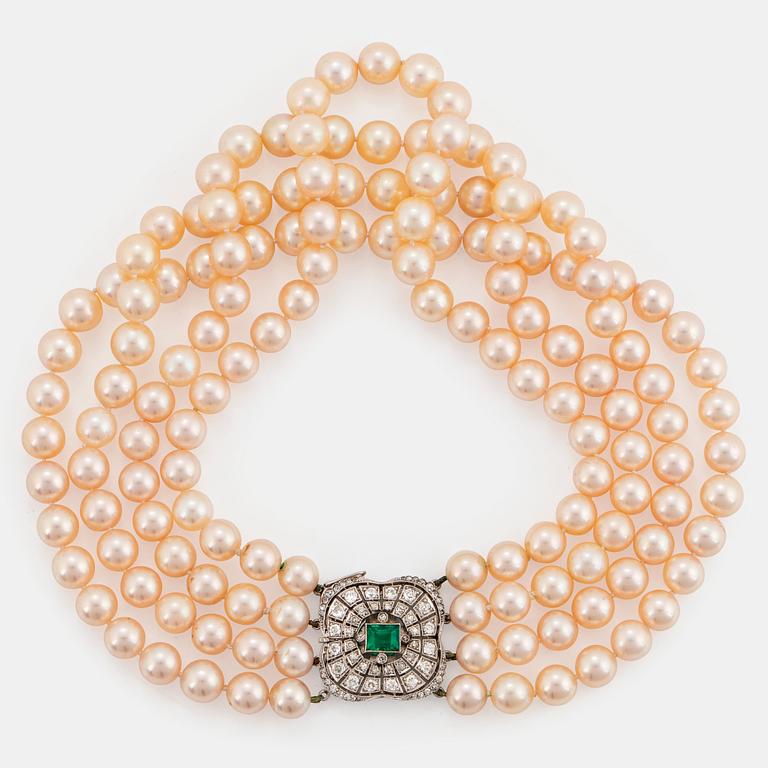 A four strand cultured pearl necklace with an 18K white gold clasp set with a faceted emerald.