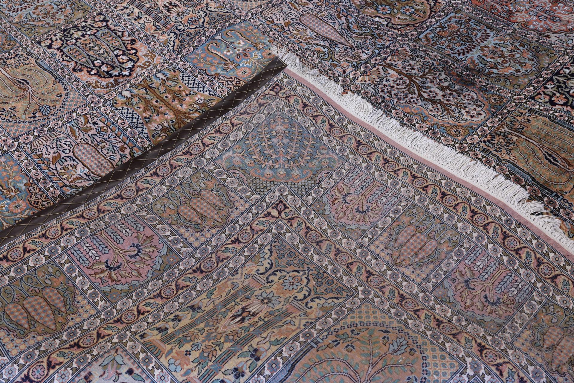 A Kashmir silk carpet, 418 x 297 cm.