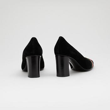 GUCCI, a pair of black suede pumps.