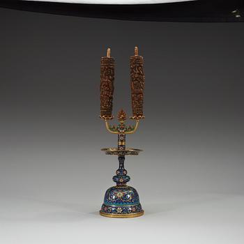 A fine Cloisonné candlestick holder with floral scrolls against a deep blue back ground, Qing dynasty, 18th Century.