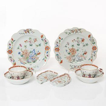 A pair of Chinese famille rose teacups with saucers and a pair of plates and two dishes, Qing dynasty, 18th century.