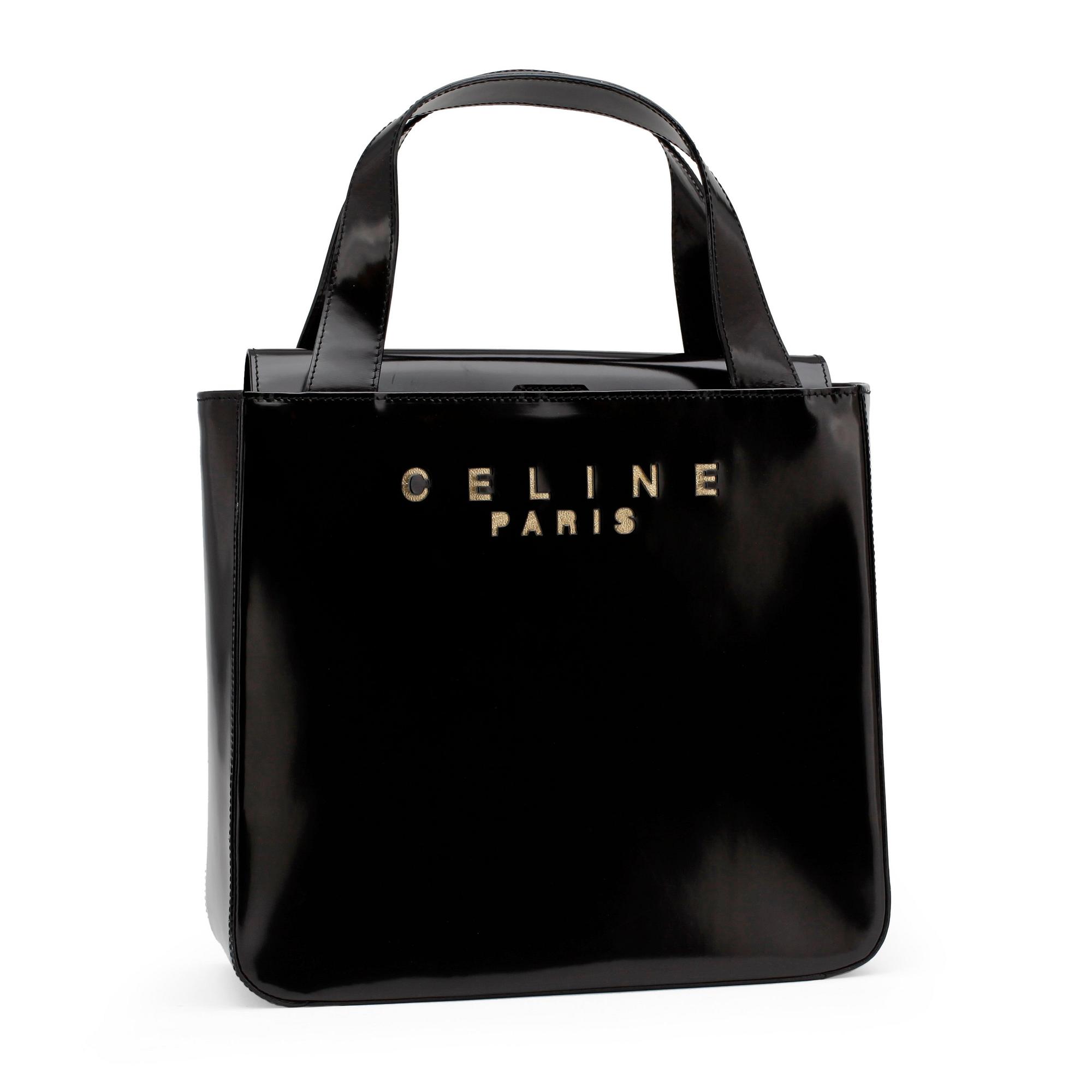CÉLINE, a black patent leather purse.