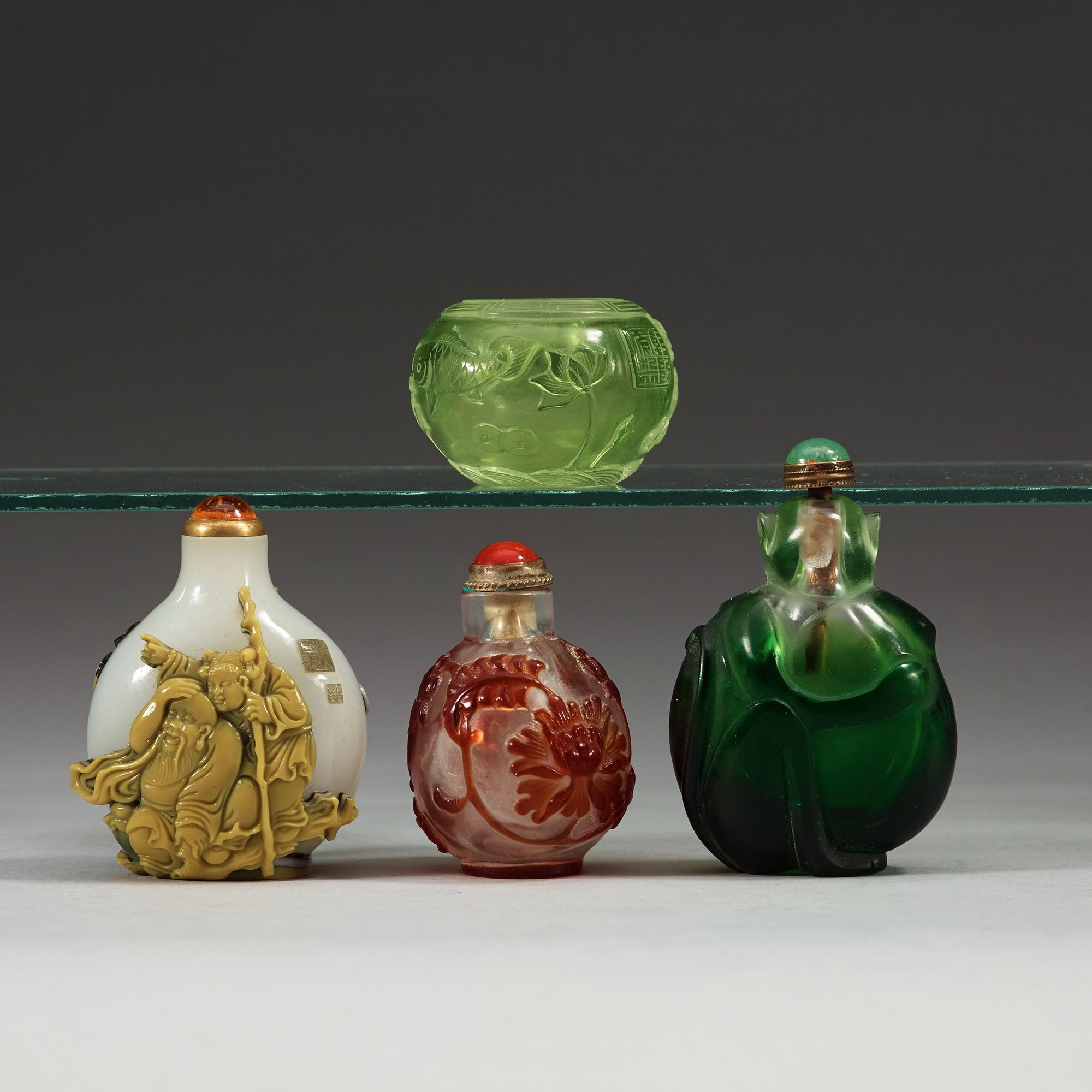 A set of three Peking glass snuff bottles with stoppers and a brush washer.