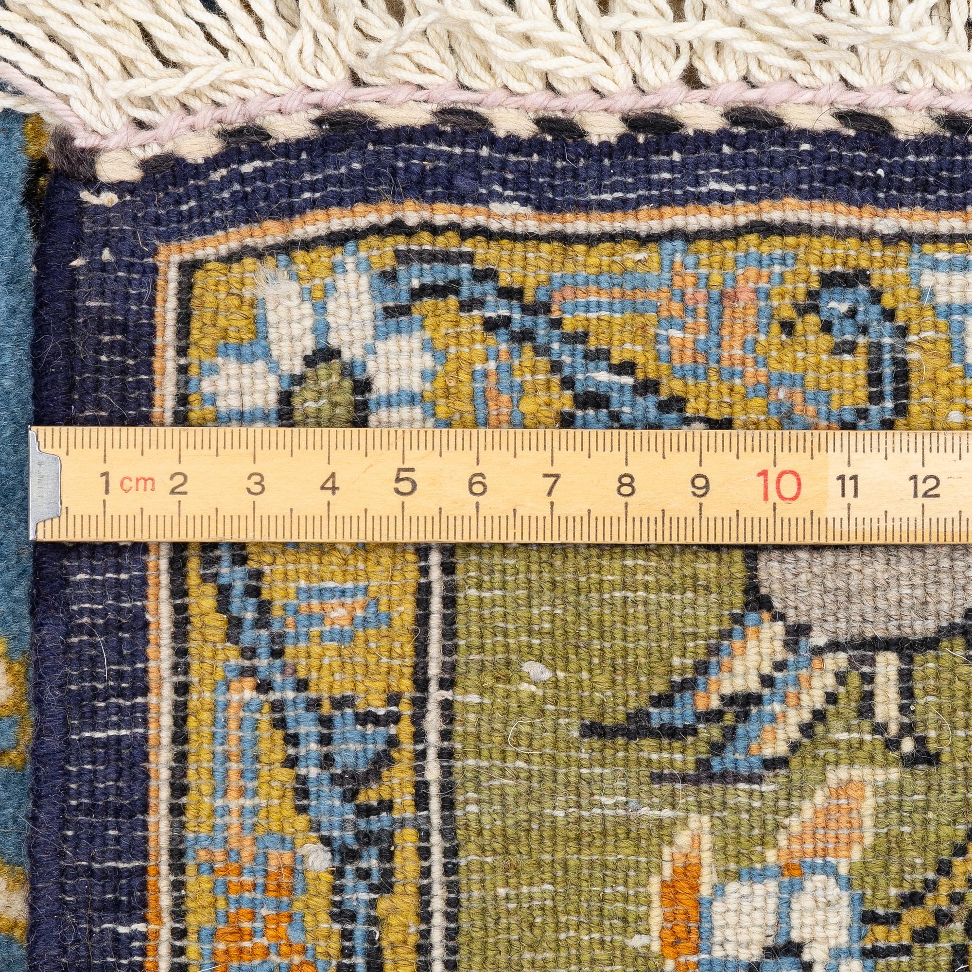 A Ghom figural rug, c. 202 x 132 cm.