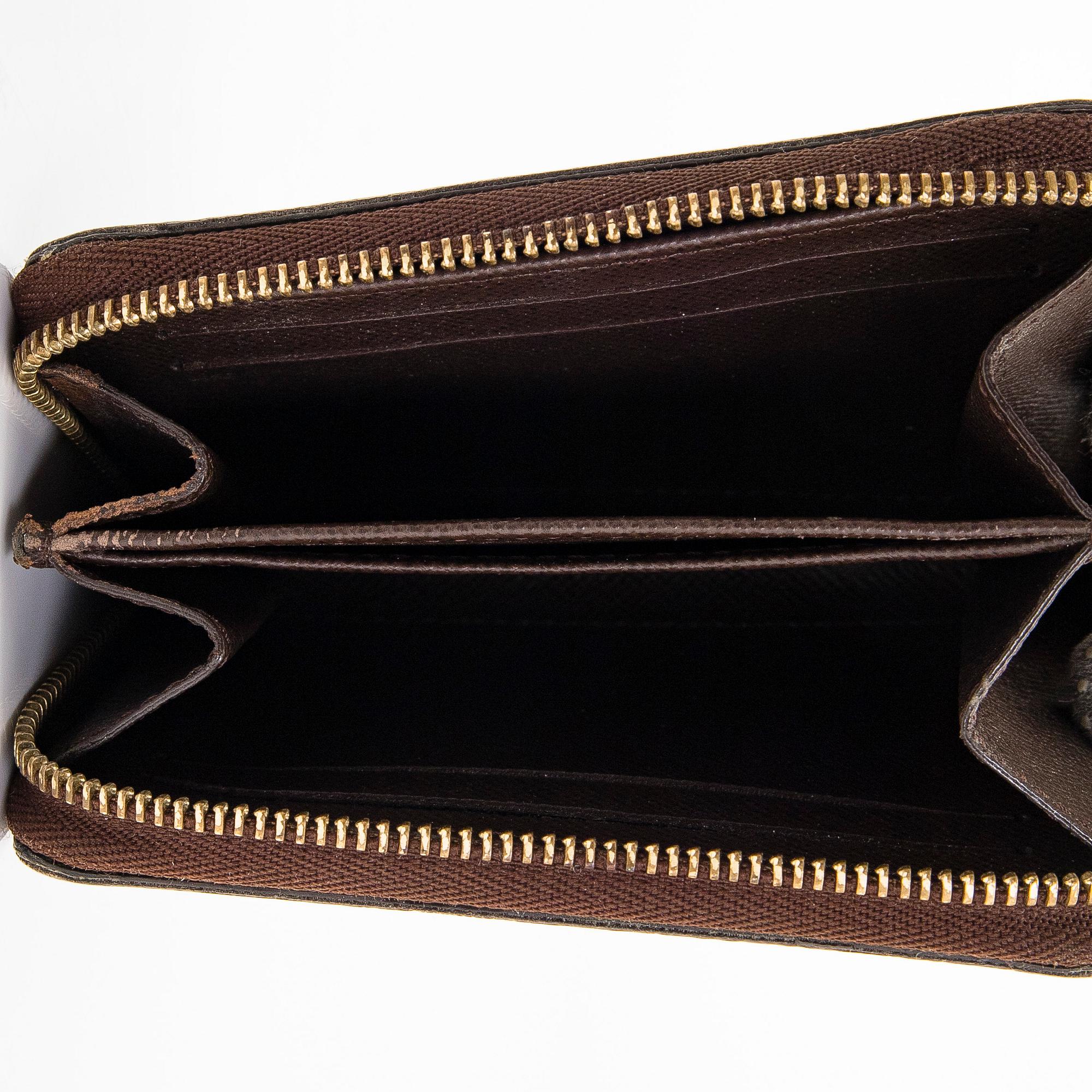 Louis Vuitton, a 'Zippy Coin Purse' wallet and an 'Inventeur' belt.