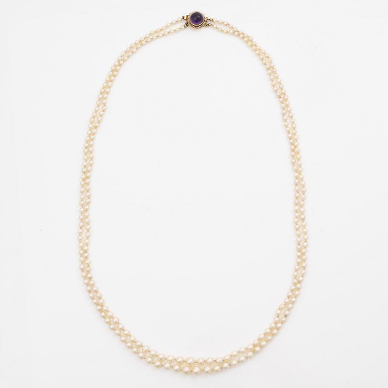 Cultured pearl necklace, double-strand with graduated pearls, Stigbert 18K gold clasp set with a cabochon-cut amethyst.