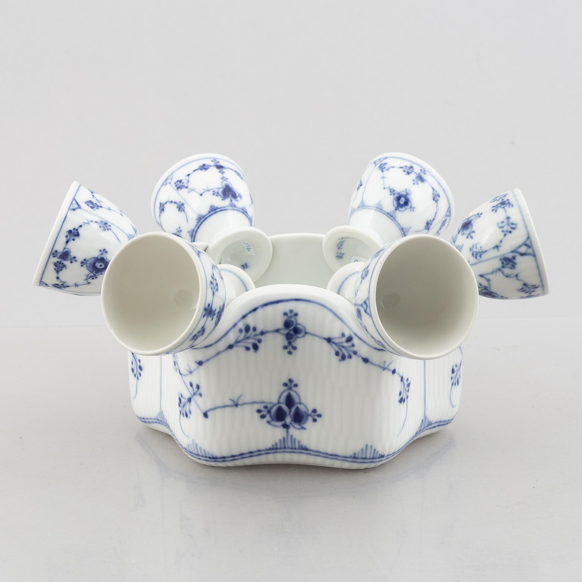 A set with six egg servers, a stand and a salt shaker, "Blue fluted"/"Musselmalet", Royal Copenhagen, part 19th century.