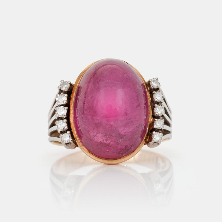 A cabochon-cut tourmaline and brilliant-cut diamond ring.