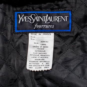 YVES SAINT LAURENT, a black lamb leather coat with fur details.