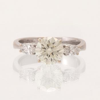 An 18K white gold ring set with one round brilliant-cut diamond and two marquise-cut diamonds.