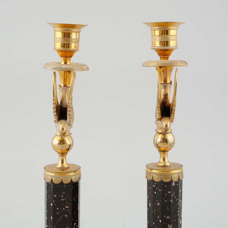 A pair of late Gustavian early 19th century porphyry and ormolu candlesticks.