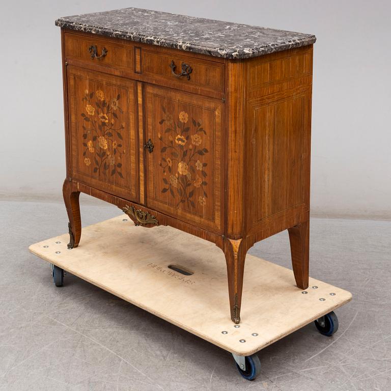 A French Louis XVI-style cupboard, ca 1900.