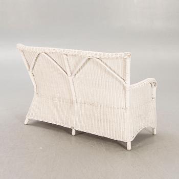 An Artwood rattan sofa.