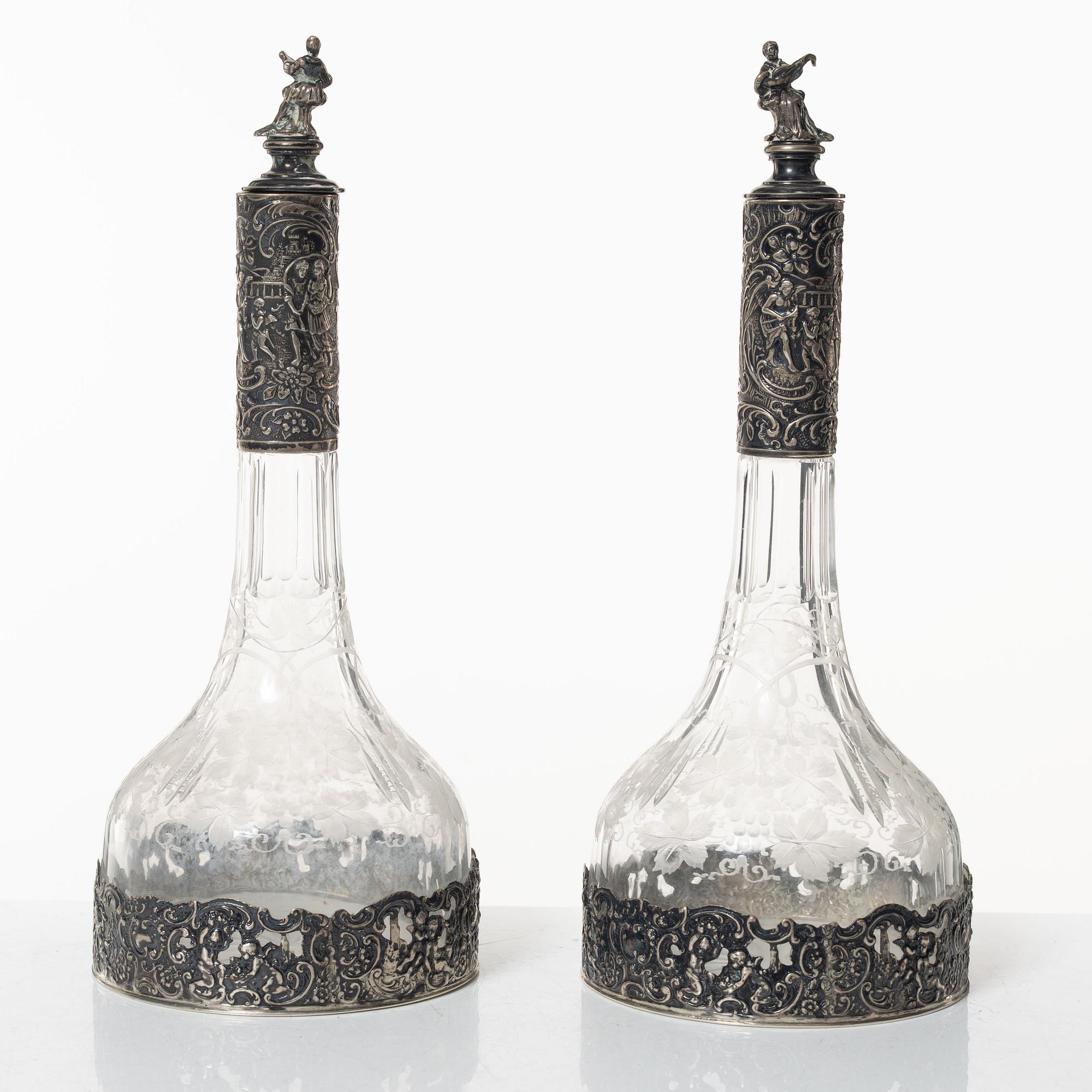 A pair of glass decanters with silver mounts, Swedish import marks, CG Hallberg, early 20th Century.