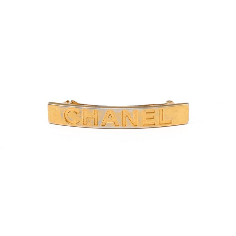 a hair barrette by Chanel.