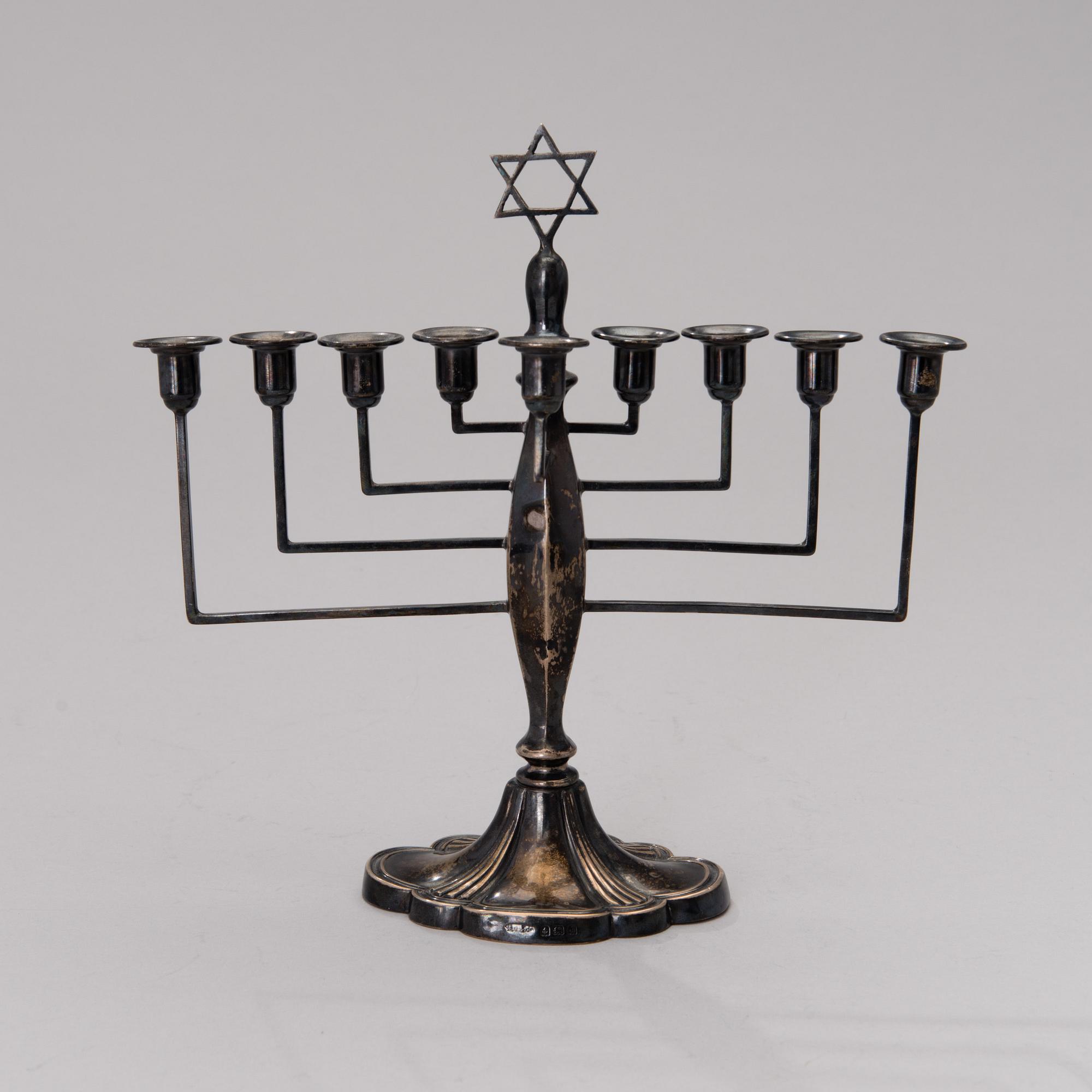 A chanukiah / menorah silver candelabrum for nine candles, mark of Britton, Gould & Co, Birmingham 1933.