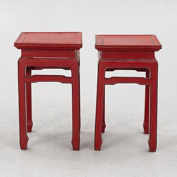 A pair of red Chinese small tables, 20th century.