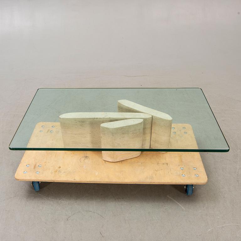 A glass and travertine coffee table later part of the 20th century.