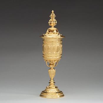 An English early 20th century silver-gilt cup and cover, mark of Goldsmith & Silversmith Co., London 1909.