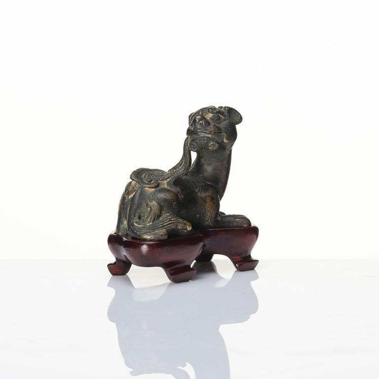 A bronze figure of a reclining beast, late Ming dynasty/early Qing dynasty.