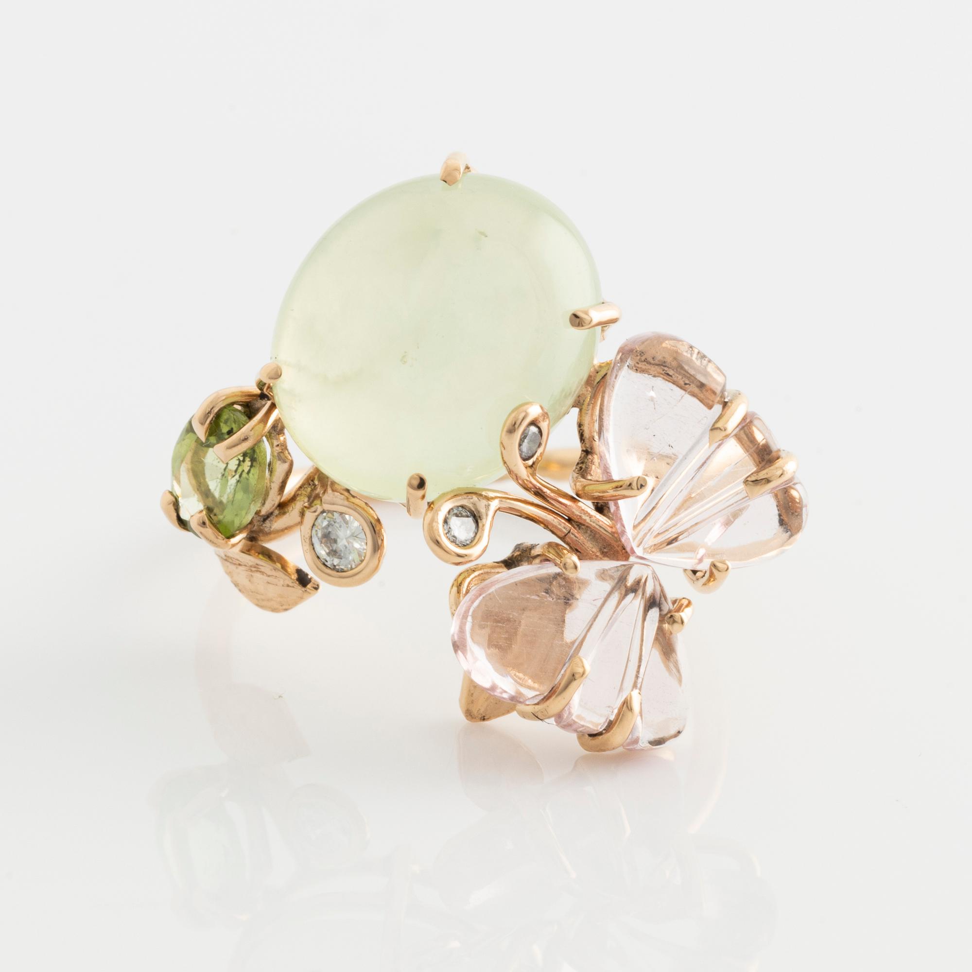 Ring with cabochon-cut prehnite, cut tourmaline in the shape of a butterfly, peridot, and brilliant-cut diamonds.