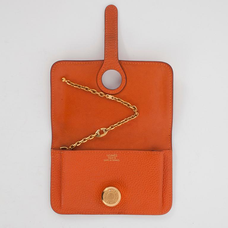 HERMÈS, a orange leather key holder.