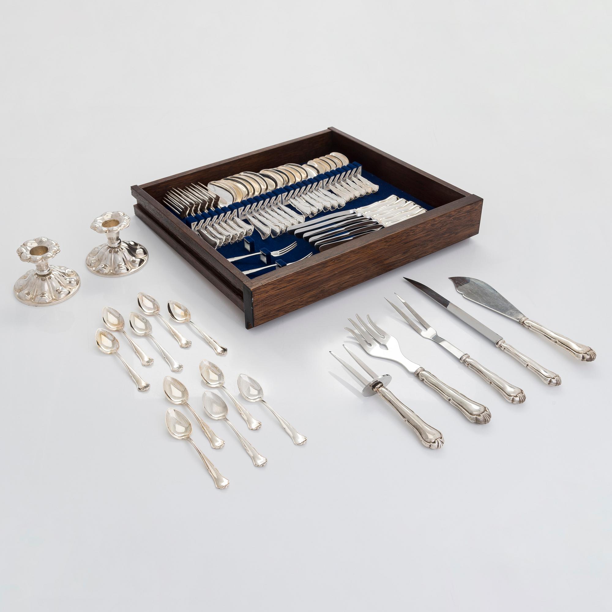A 47-piece set of 'Chippendale' silver cutlery and a pair of silver candlesticks, Finnish marks 1983-2003 and 1976.