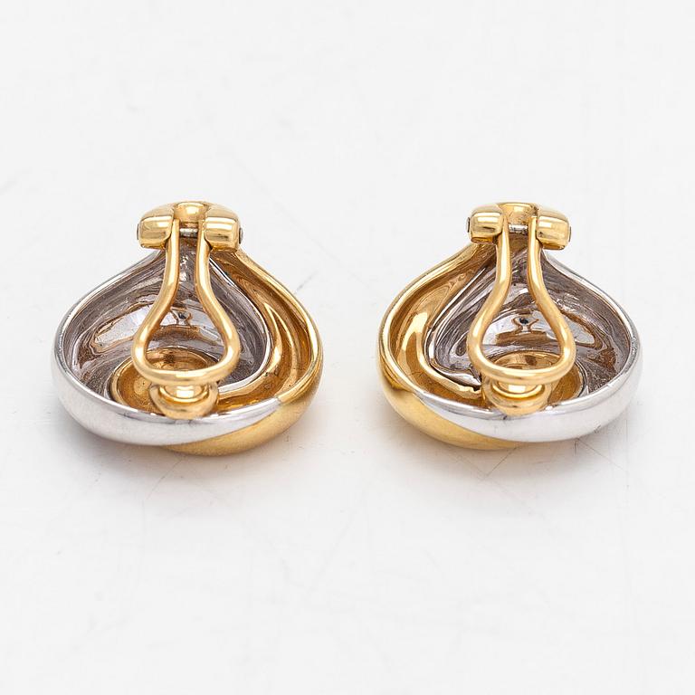A pair of 18K white and yellow gold earrings.