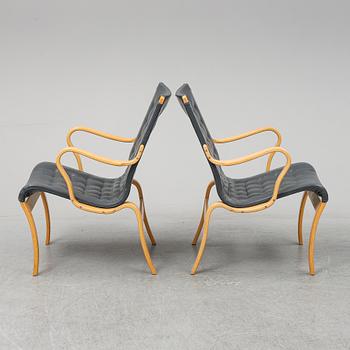 A second half of the 20th Century pair of 'Mina' armchairis by Bruno Mathsson for Mathsson International.