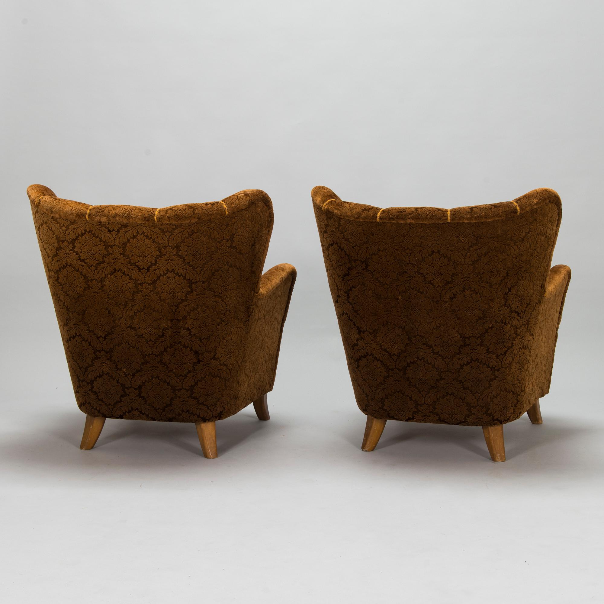 A pair of mid-20th-century armchairs.