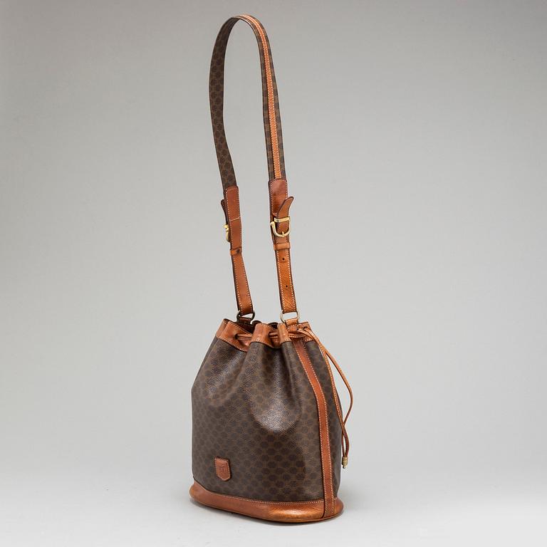 CÉLINE, a monogram canvas bucket bag.