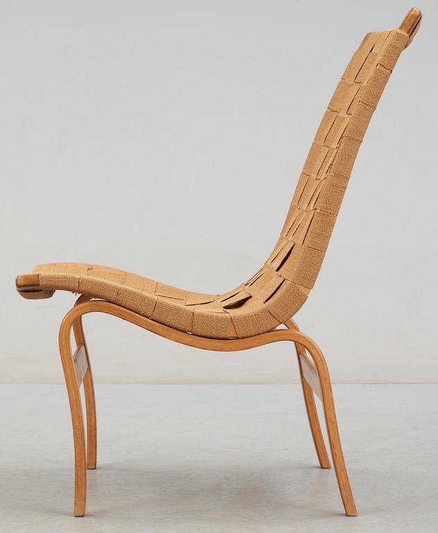 A Bruno Mathsson beech and canvas easy chair, 'Eva', Karl Mathsson, Värnamo, Sweden 1940's.