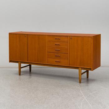 A 1960's teak vaneered sideboard.