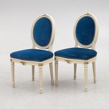 A Gustavian style dining table and eight chairs, late 20th century.