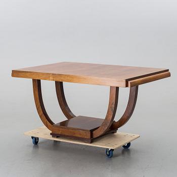 A french art deco dining table with extra boards.