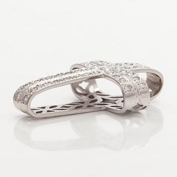 An 18K white gold cross pendant with diamonds.
