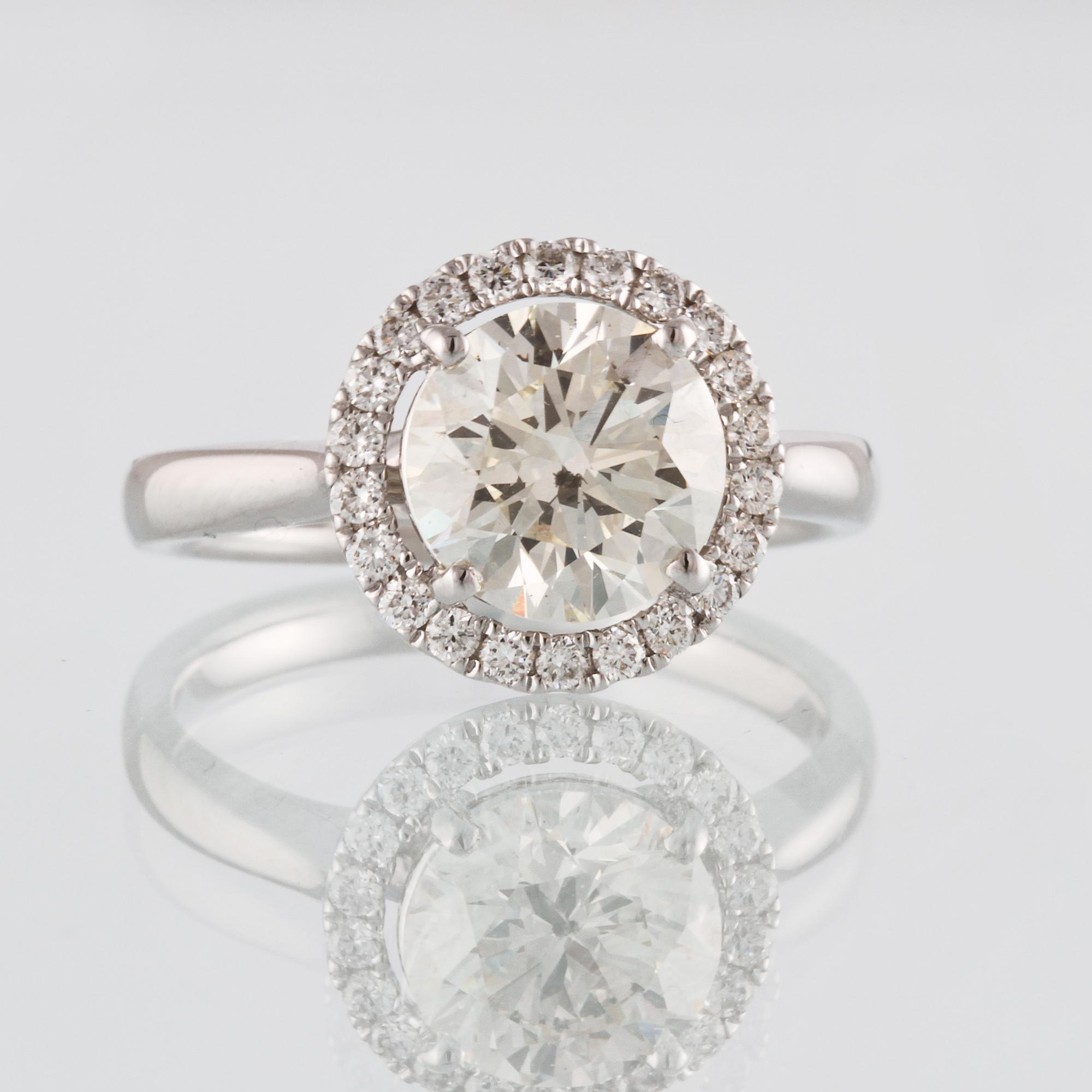 RING, 18K vitguld med briljantslipad diamant ca 2.03 ct samt små briljantslipade diamanter 0.24 ct. 4,8 gram.