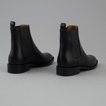 Black leather boots by Yves Saint Laurent.