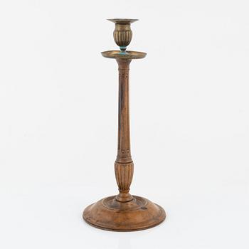 A George III mahogany and brass candlestick, circa 1800.